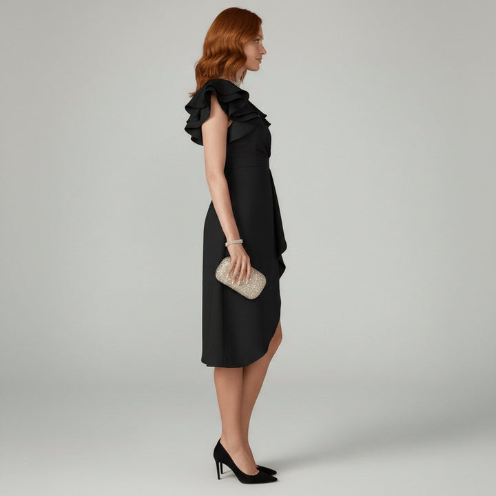 Side profile of black wrap dress showing layered ruffle sleeve and midi hem