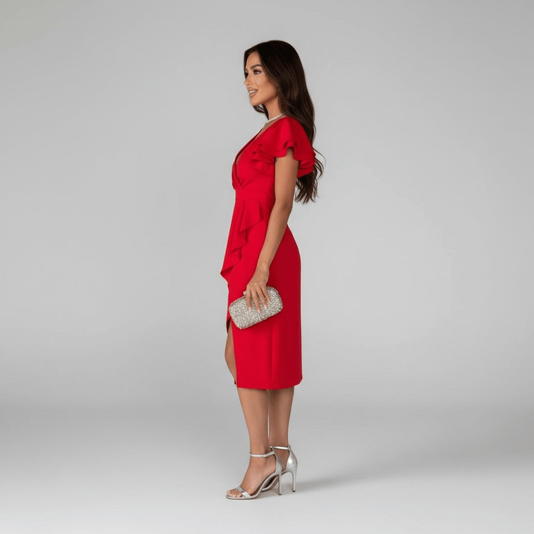 Side angle of red ruffle sleeve dress highlighting wrap waist and leg slit