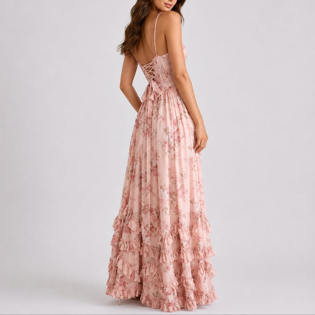 Back view of pink floral maxi dress featuring lace-up bodice and bow accent