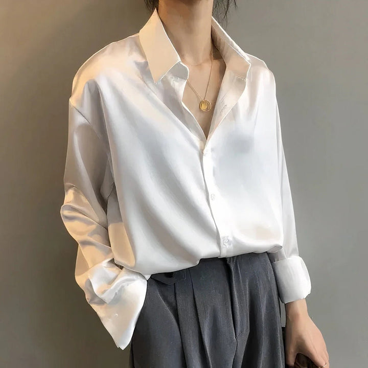 White satin button-down blouse with layered pendant necklace, oversized fit