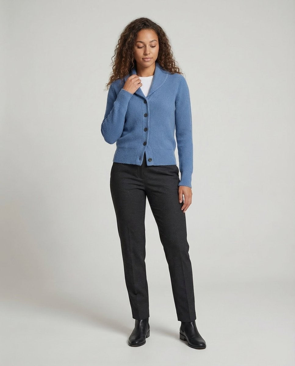 Blue ribbed knit cardigan with shawl collar styled over gray trousers