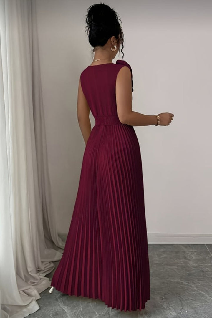 back view of burgundy sleeveless pleated maxi dress with shoulder bow