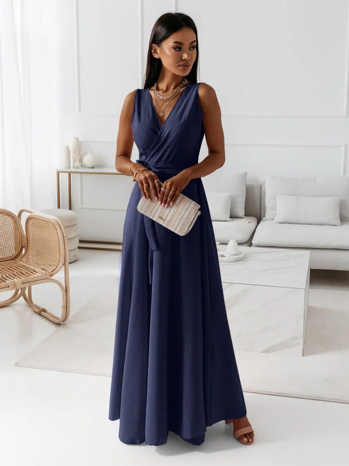 Navy blue wrap maxi dress with V-neck, tie waist, and sleeveless design