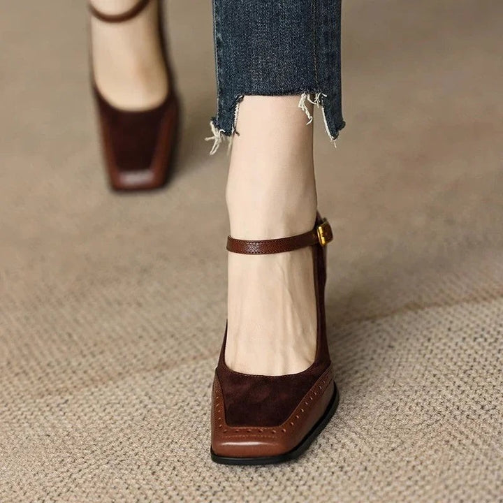 close-up of brown block heel pumps with buckled ankle strap