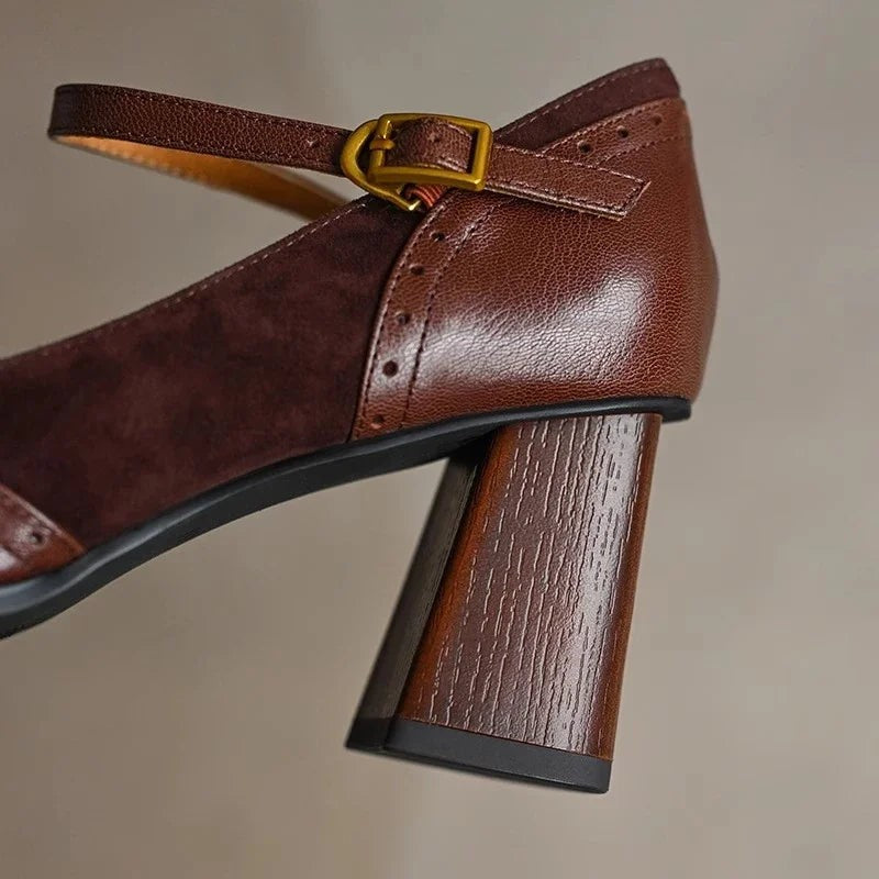 close-up of gold buckle strap on brown leather block heel shoe