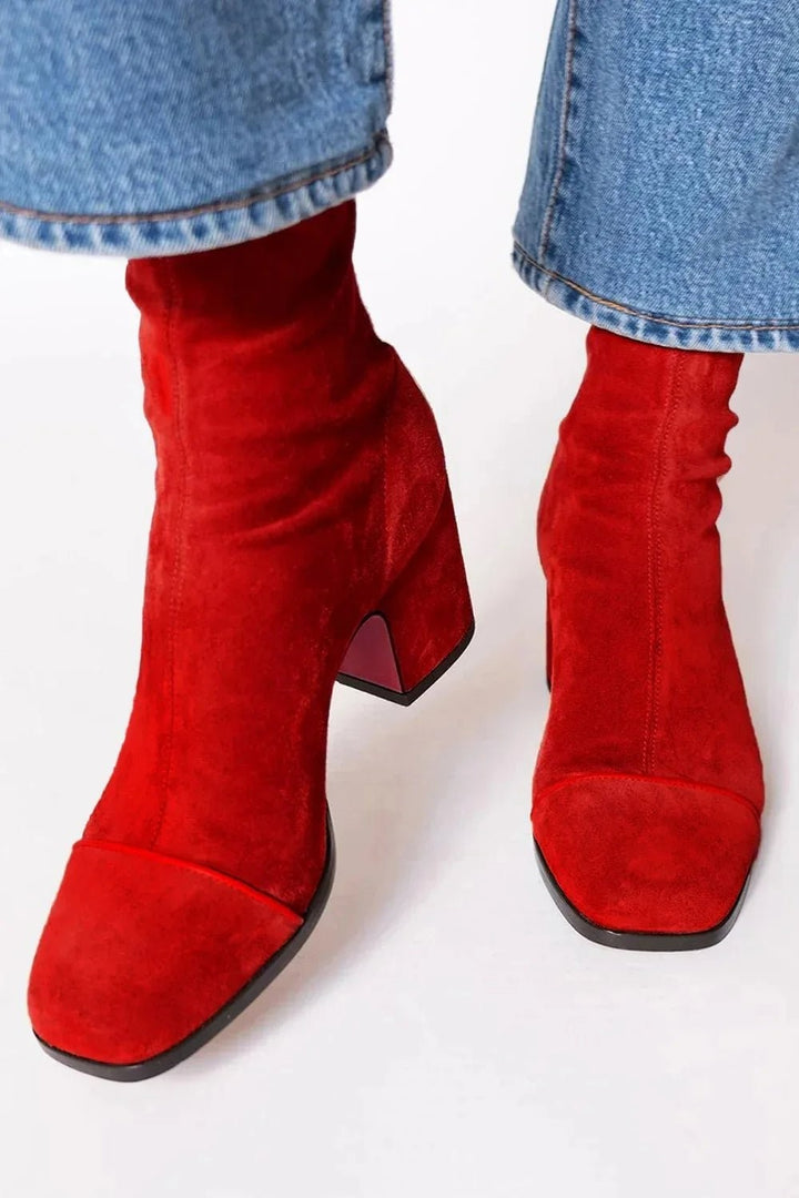 red suede ankle boots with square toe worn with straight-leg jeans