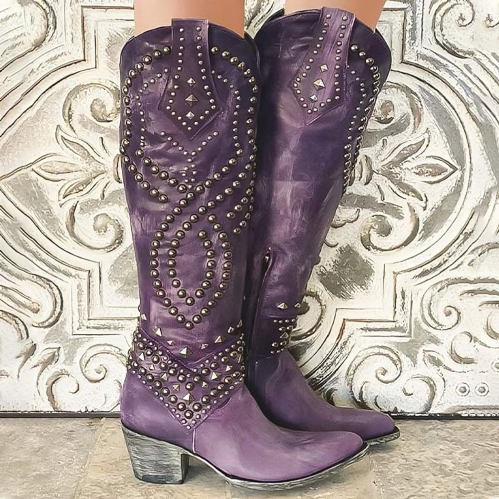 Purple leather knee-high cowboy boots featuring studded pattern and stacked heel