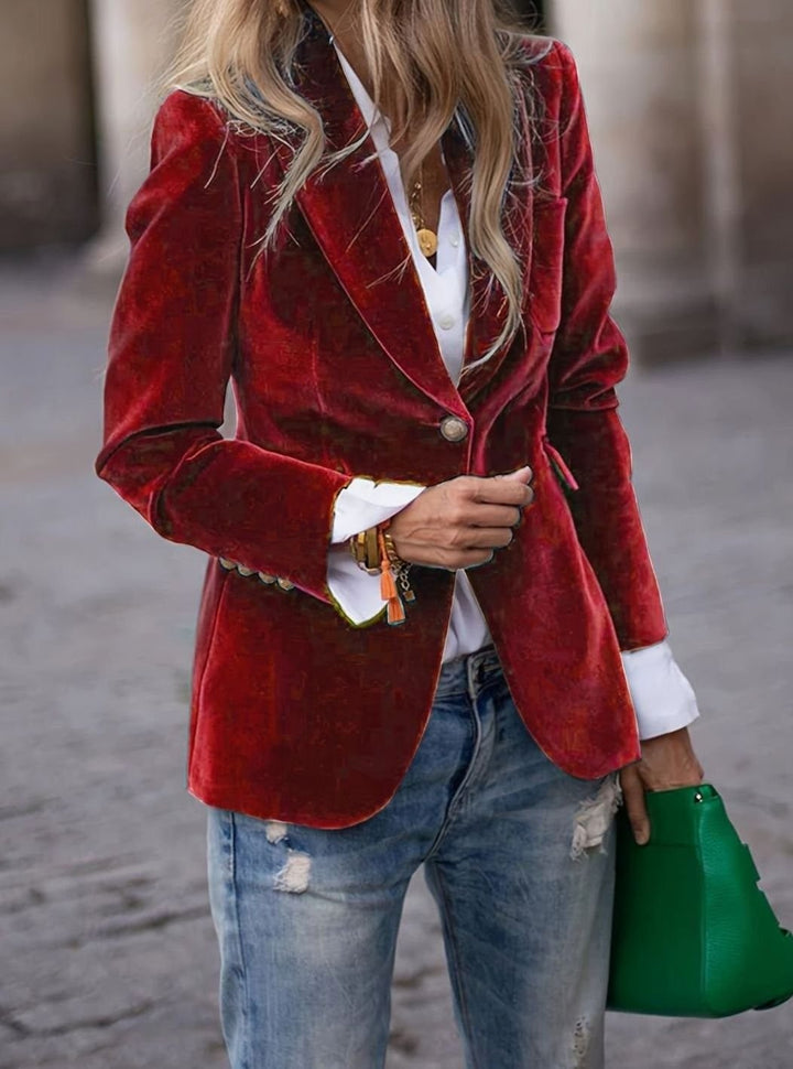 Red velvet single-button blazer worn over white shirt and ripped jeans