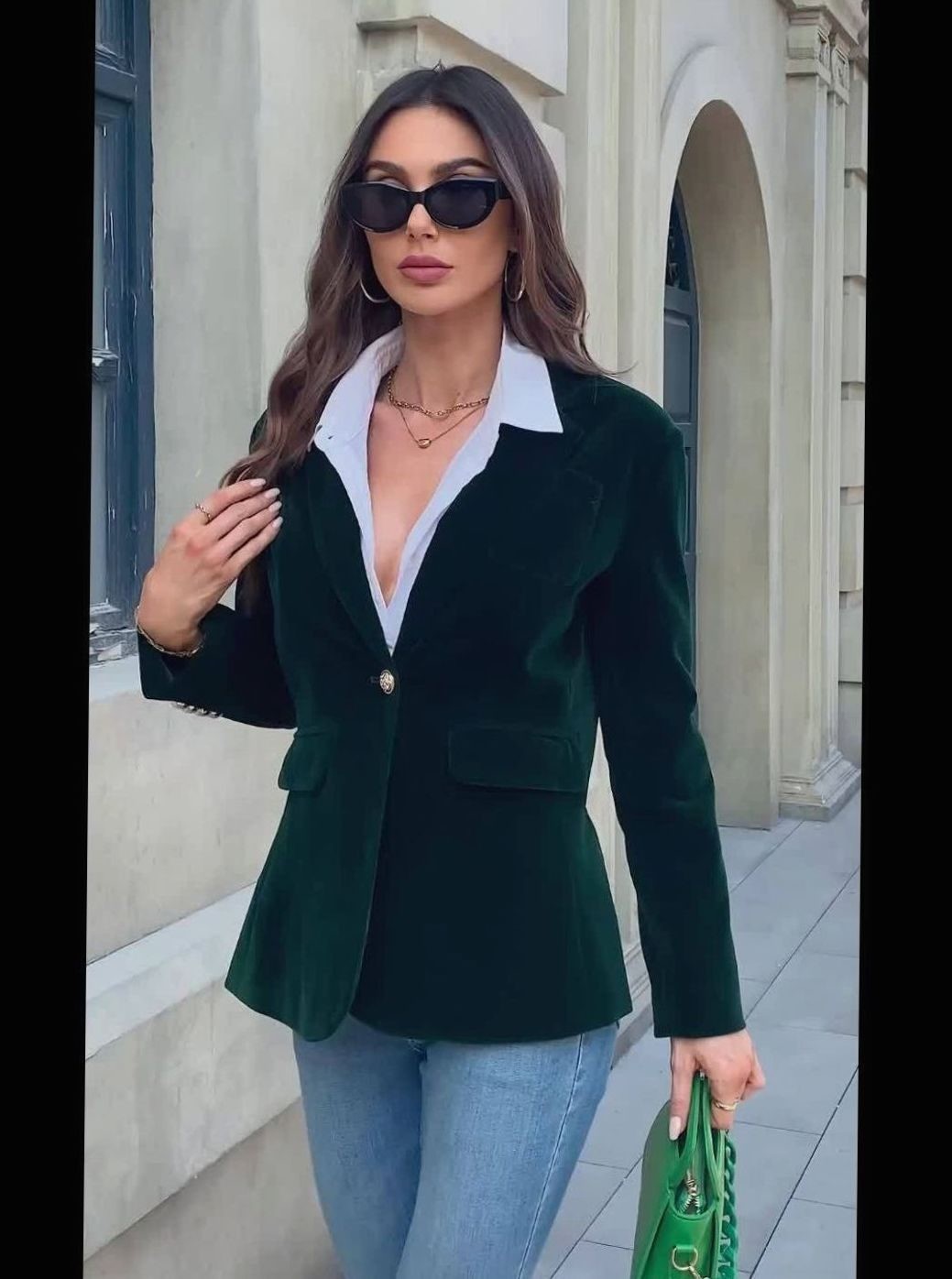 Emerald velvet blazer with flap pockets worn over white collared shirt