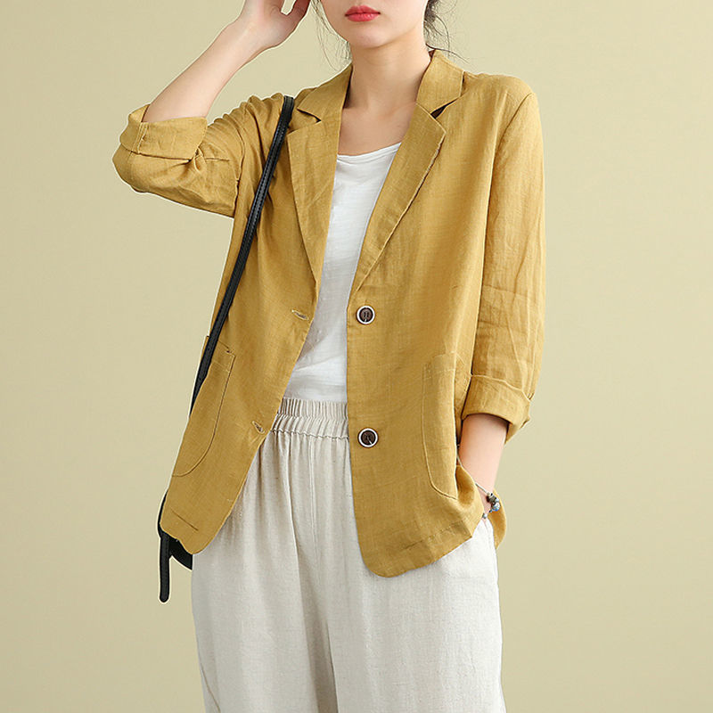 Mustard yellow linen blazer featuring rolled sleeves and front pockets