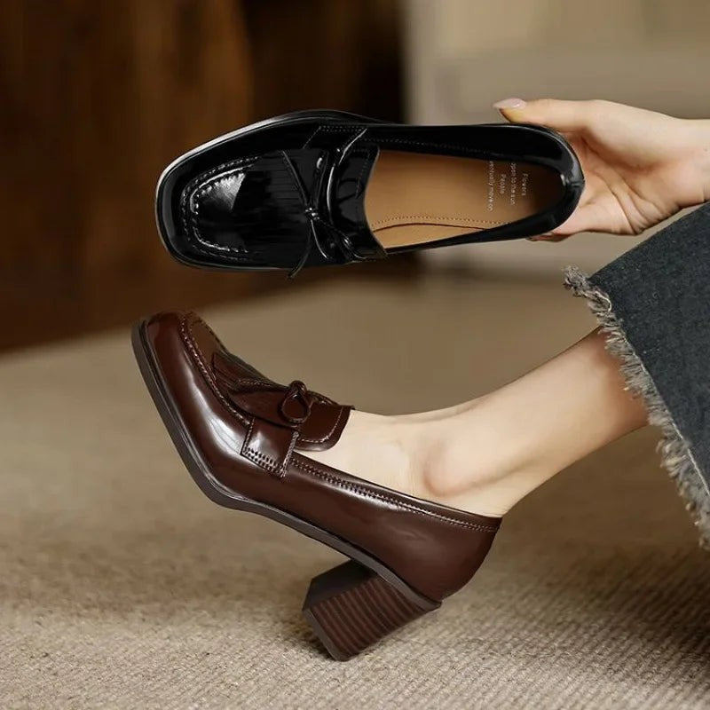 top view of brown tassel loafer pump showing fringe and bow detail