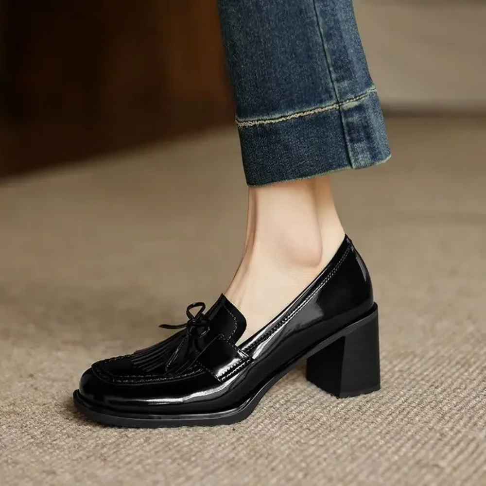 side view of black patent tassel loafer pump with chunky block heel