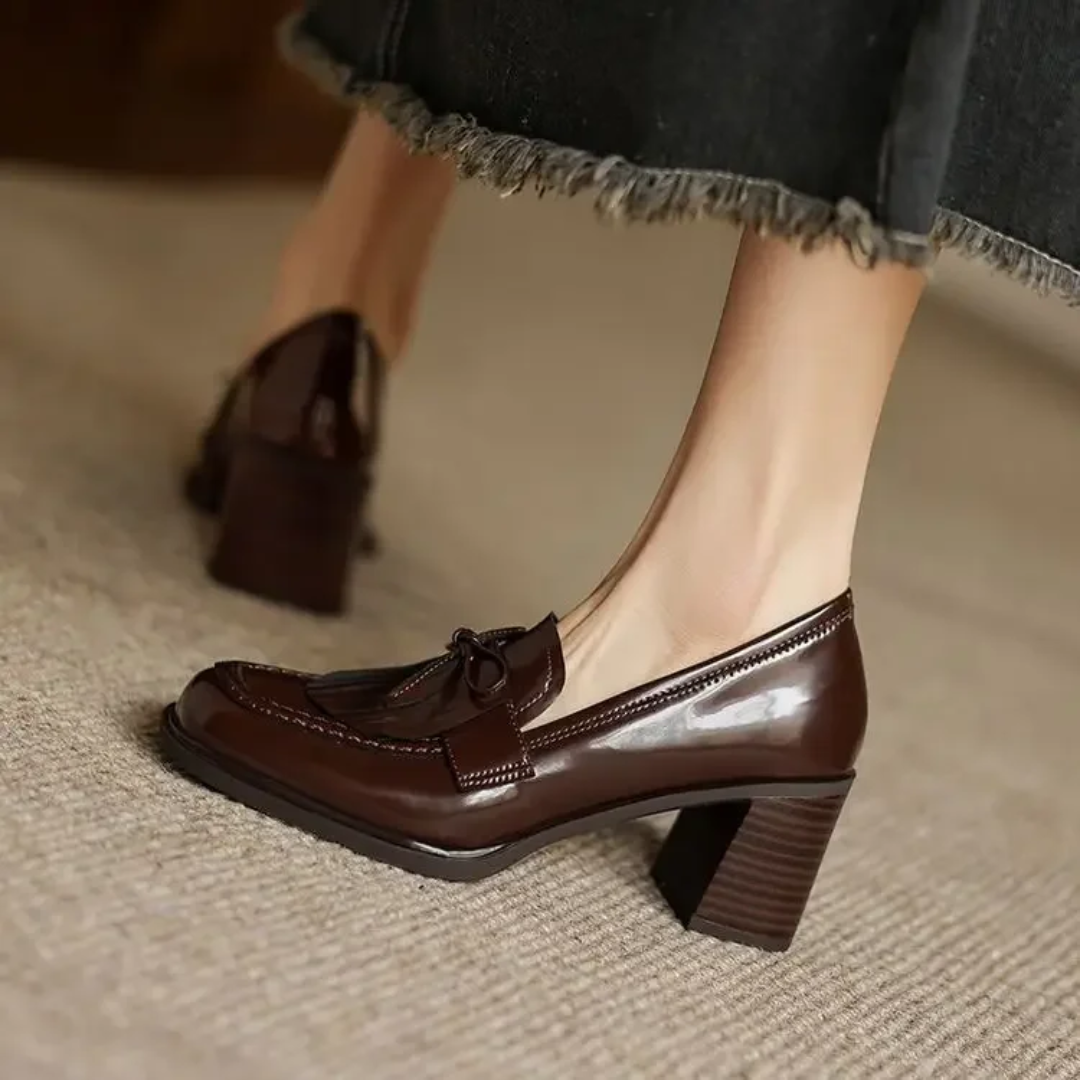 brown patent tassel loafer pumps worn with a frayed denim skirt