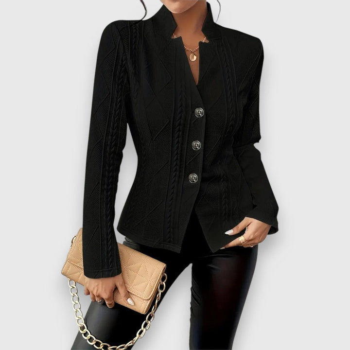 black cable-knit textured jacket with button closure, close-up view