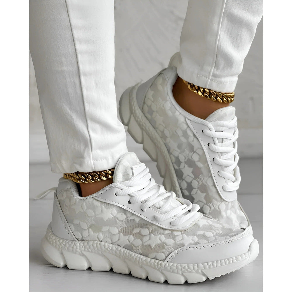 White lace-textured platform sneakers featuring bold lace-up laces and thick ridged outsole