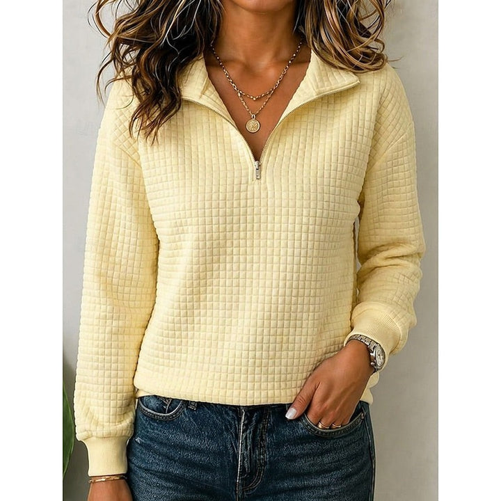 Pale yellow quarter-zip pullover with textured checkered knit fabric