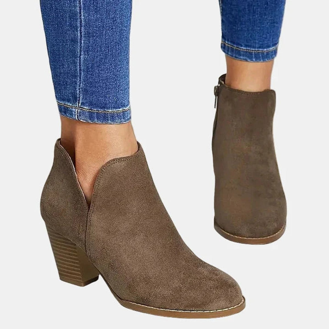 Side view of taupe suede booties featuring V-cut topline and block heel