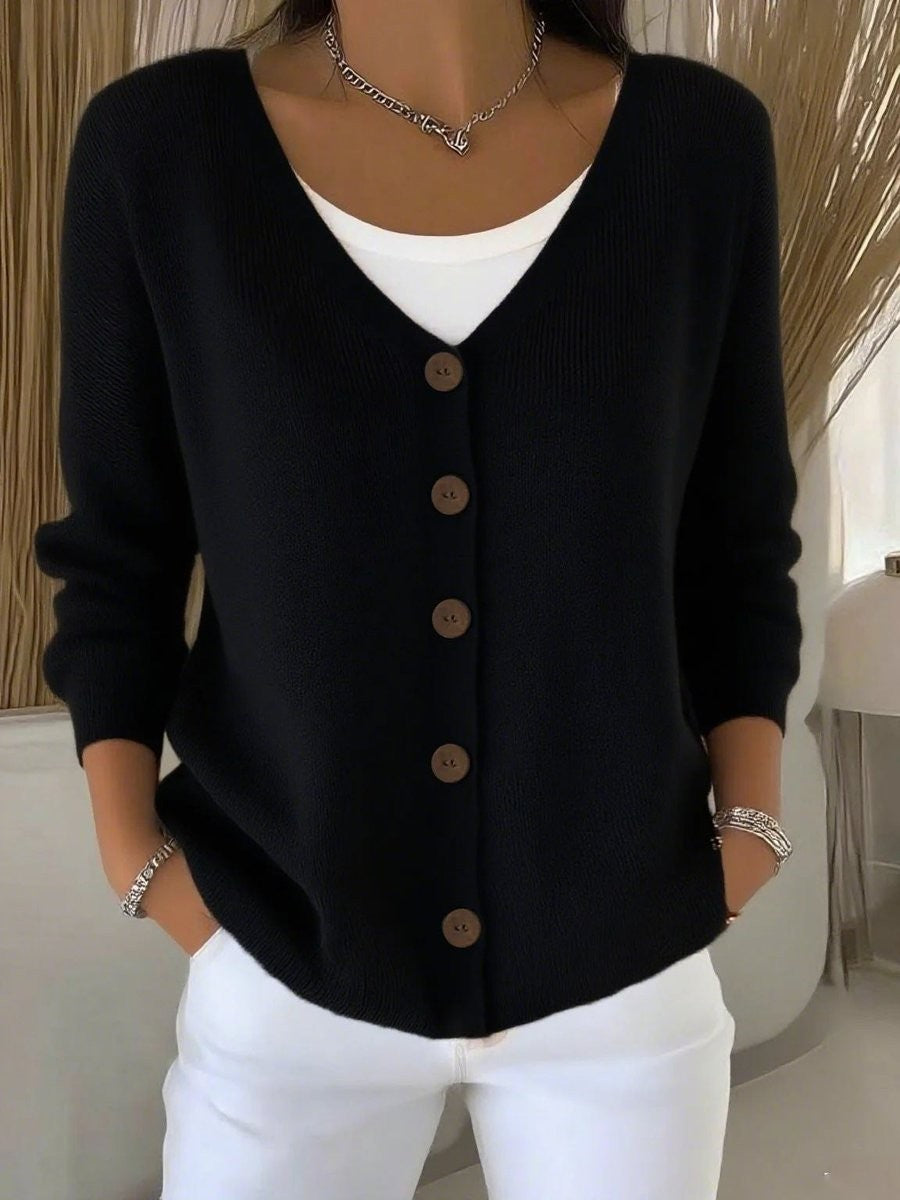 Black V-neck button-front knit cardigan sweater layered over white top