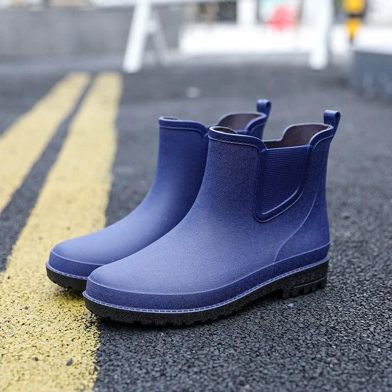 navy blue waterproof Chelsea ankle boots with pull tab on pavement