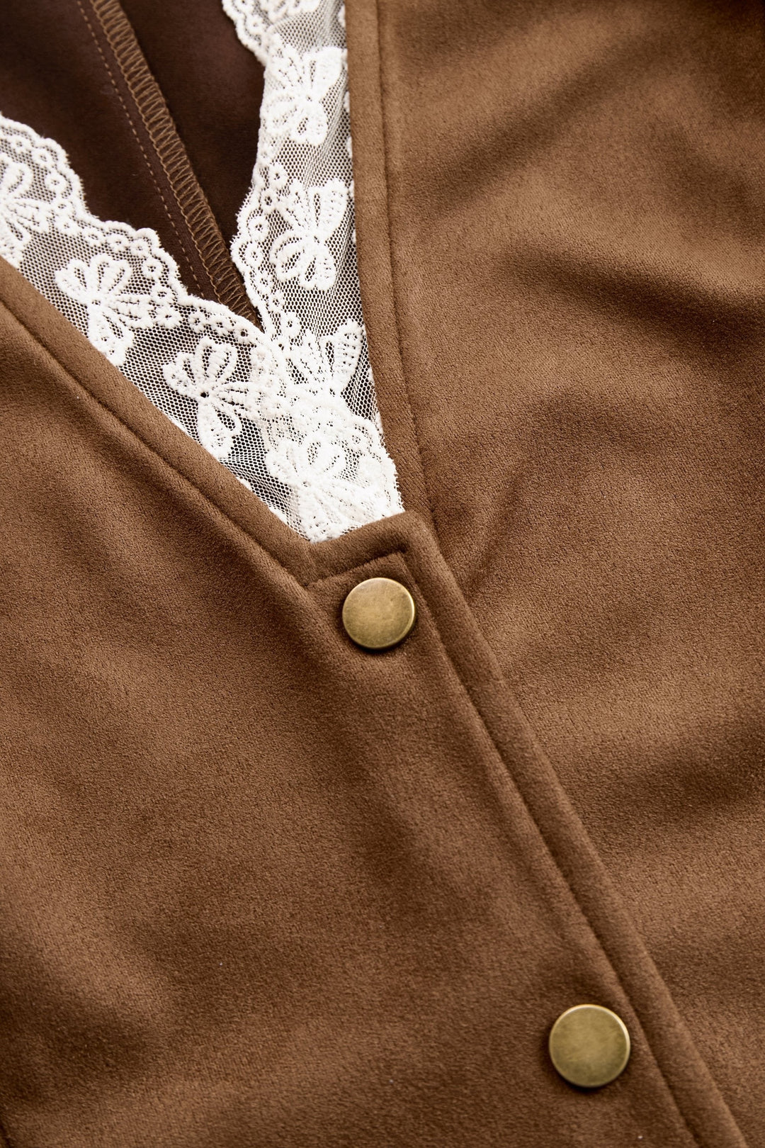 Antique brass snap buttons on brown suede vest with lace inset detail