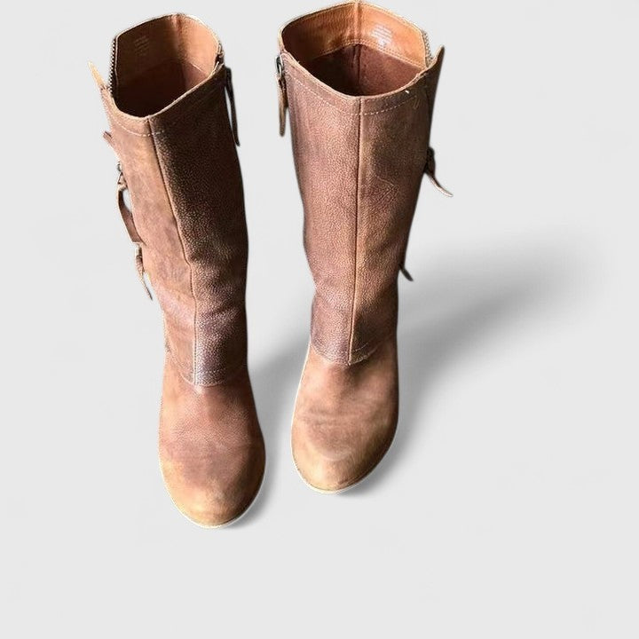 top view of brown leather mid-calf boots with side buckle straps