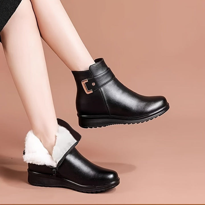 Black leather ankle boots with plush white fur lining folded down