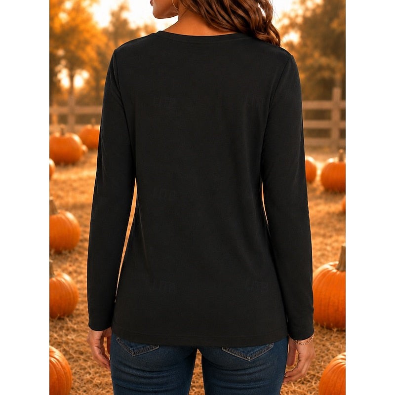 Back view of black crew neck long-sleeve top in pumpkin patch setting