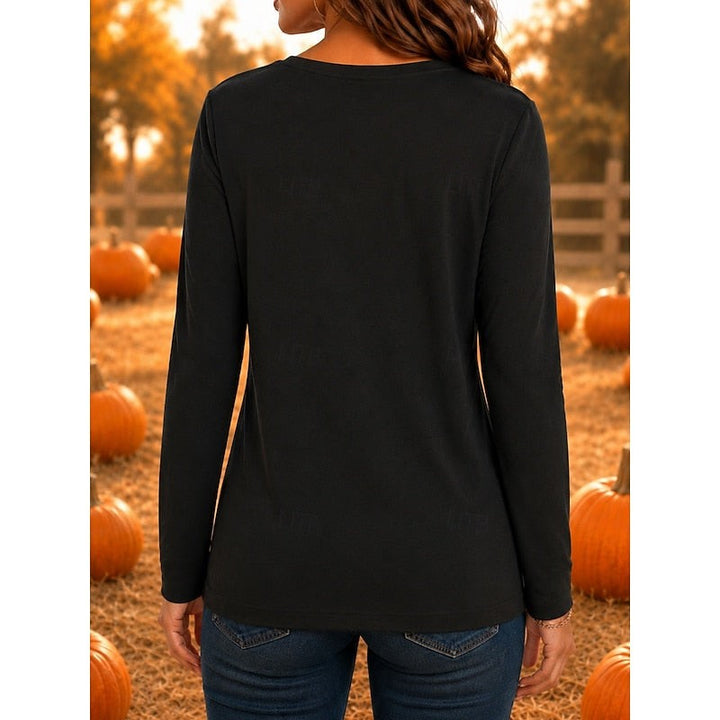 Back view of black crew neck long-sleeve top in pumpkin patch setting